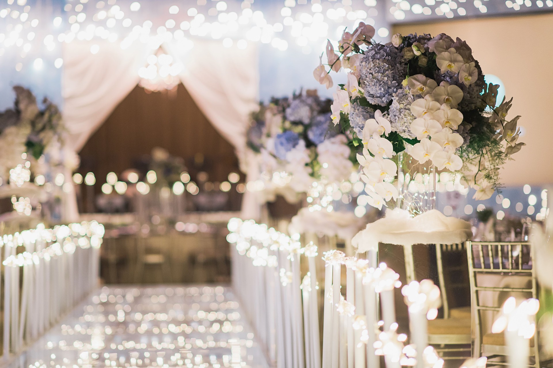 luxury color theme wedding solemnisation dinner flower florist , dinnerware banquet, cloth and stage lighting decoration design in premium hotel ballroom and beautiful beach event