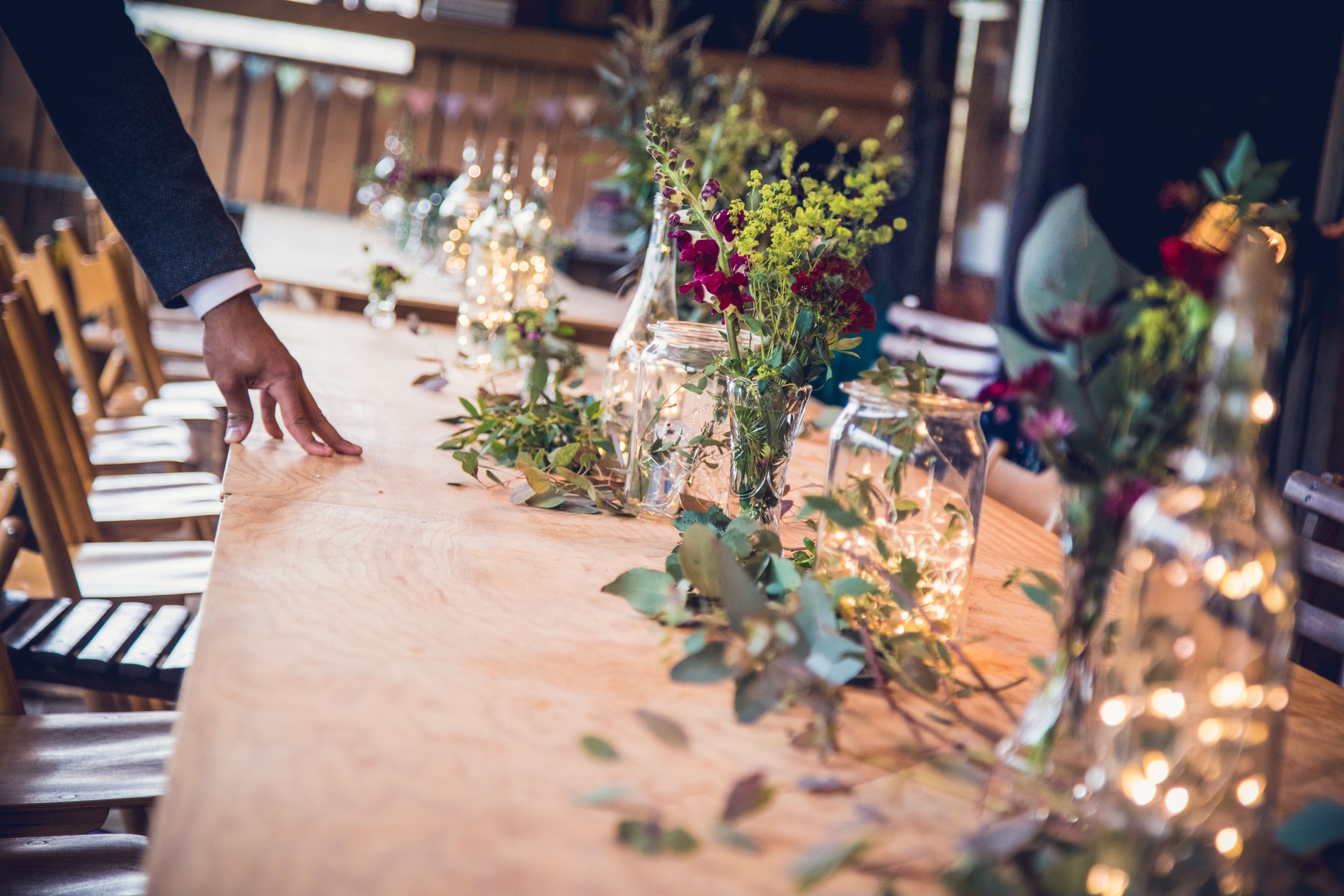 Elegant wedding reception table adorned with flowers and lights in a festive atmosphere