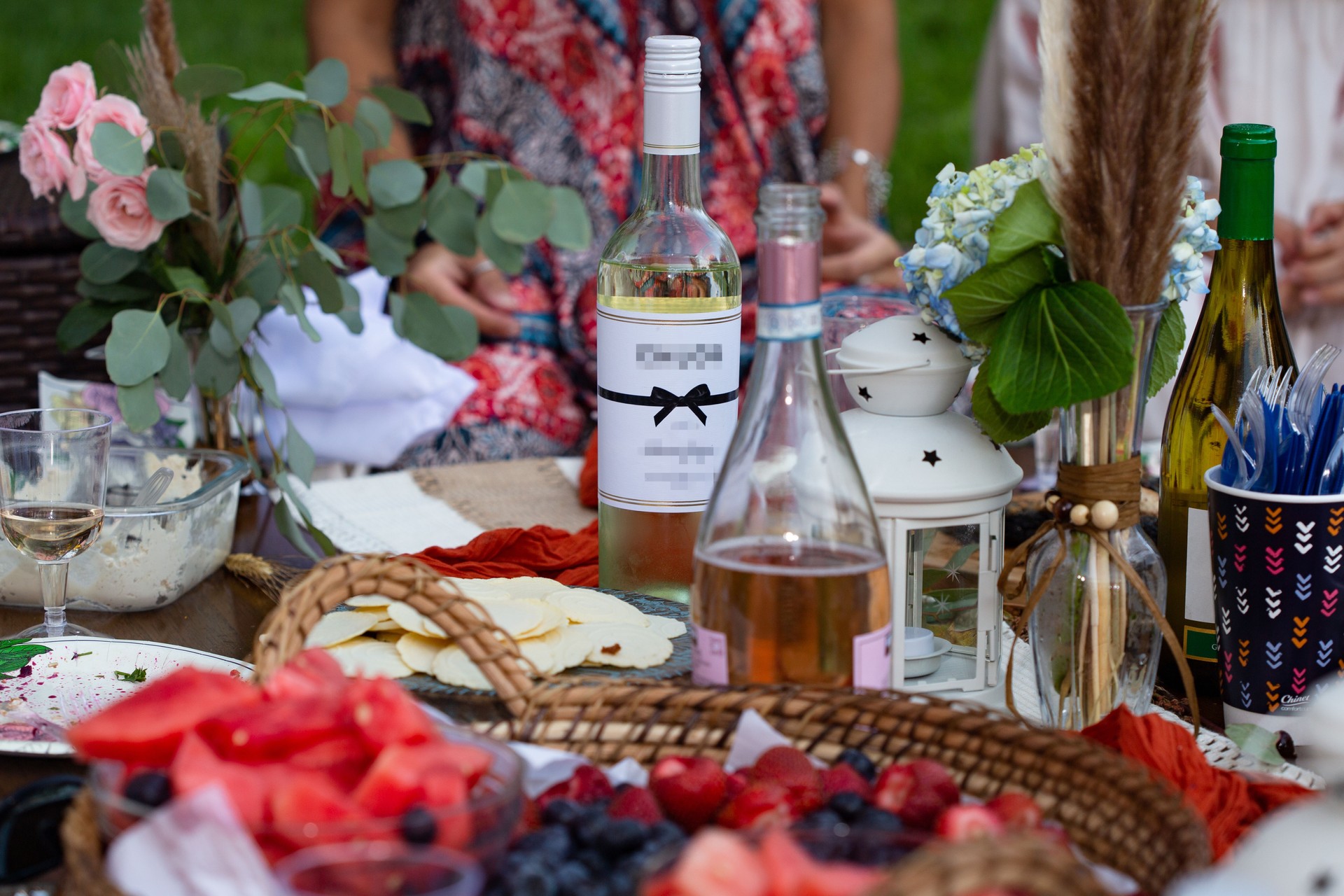 Babyshower on the air picnic with wine and fruits